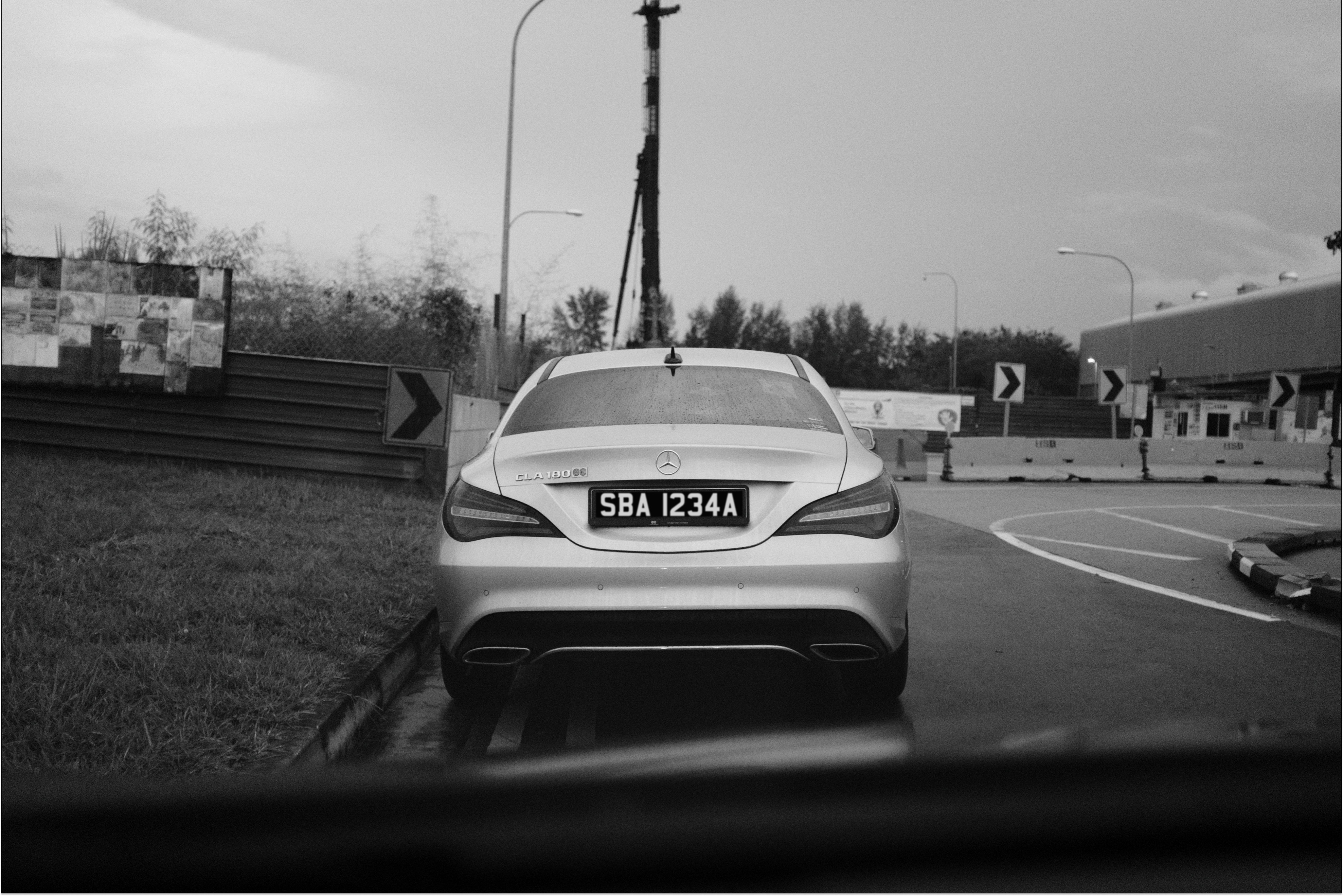 grayscale photo of car on road